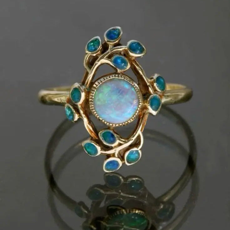Bague rétro bleue avec cristaux et opale en or