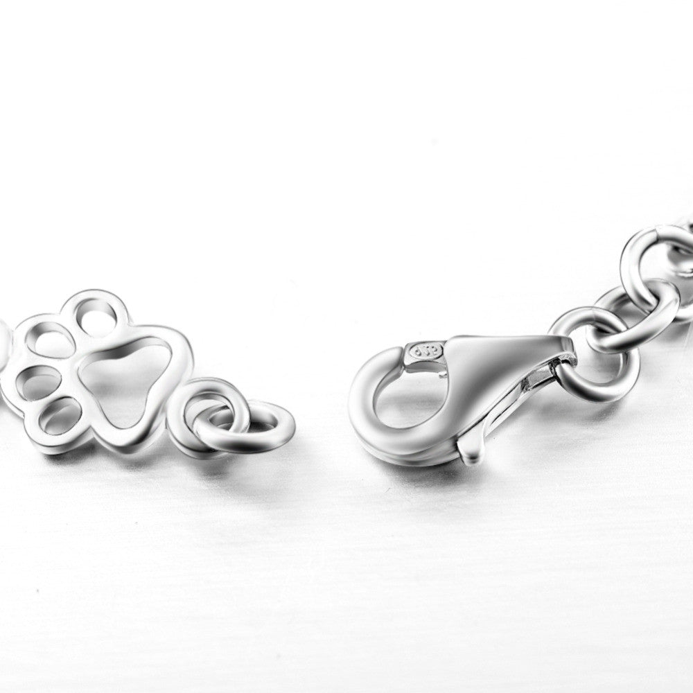 Bracelet avec pattes de chien suspendues et Os Brut, Édition limitée en or blanc