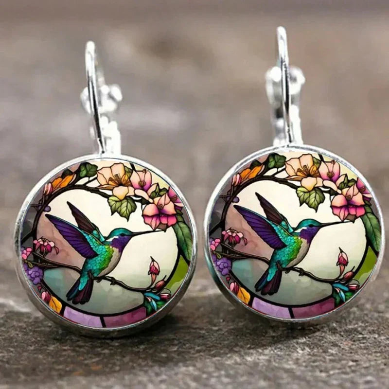 Collier avec pendentif en métal en forme d'hirondelle avec dôme en verre en or